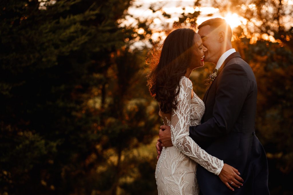 Bride and Groom laughing together at golden hour by Manchester Wedding Photographer, Kyle Hassall