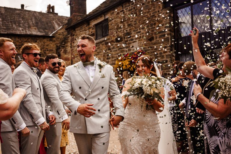 Bride and Groom walking through confetti