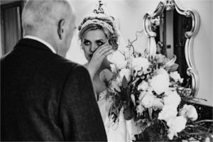 Bride wiping a tear away from her eye