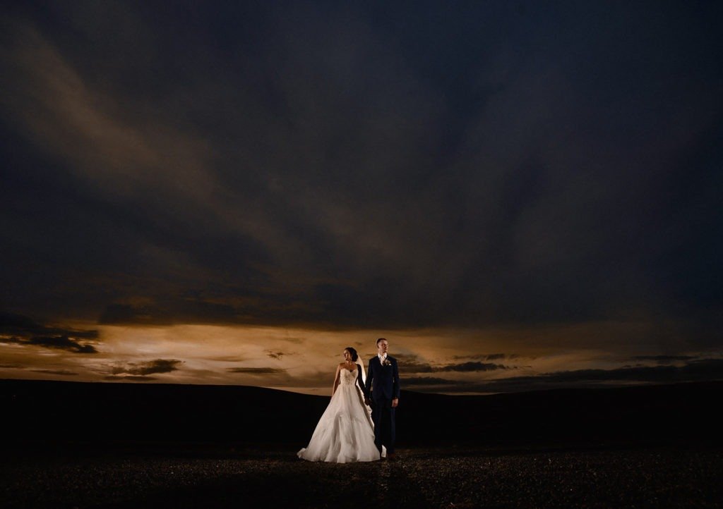 Photograph of the Bride and groom standing in front of a beautiful Manchester sunset