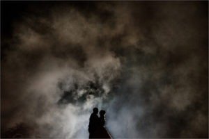 Bride and groom surrounded by smoke