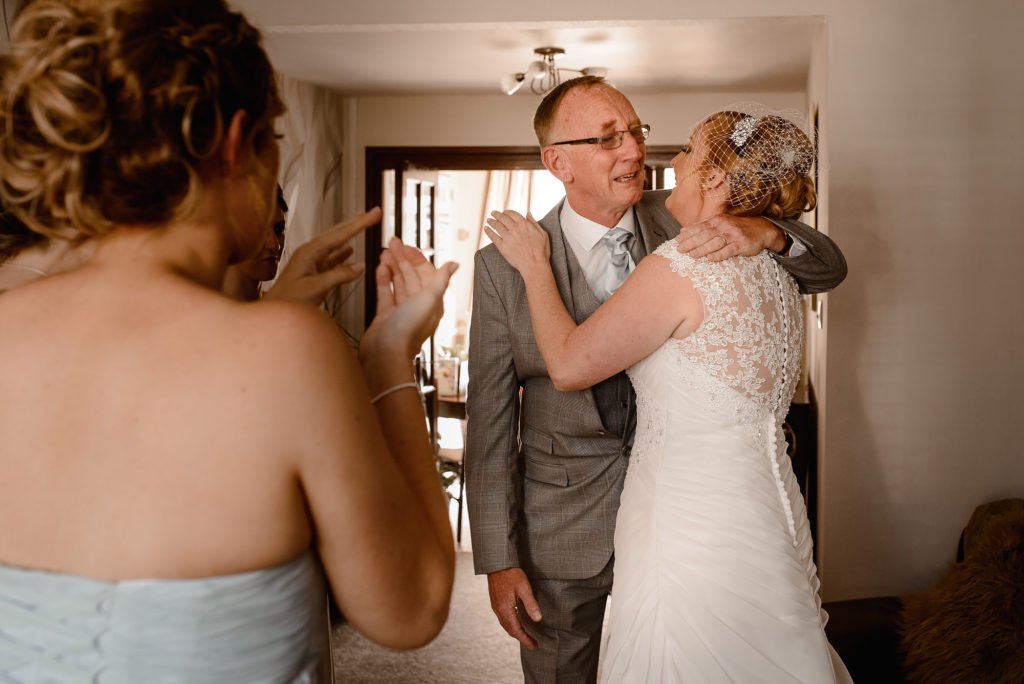 Bride's dad becoming emotional as he hugs his daughter
