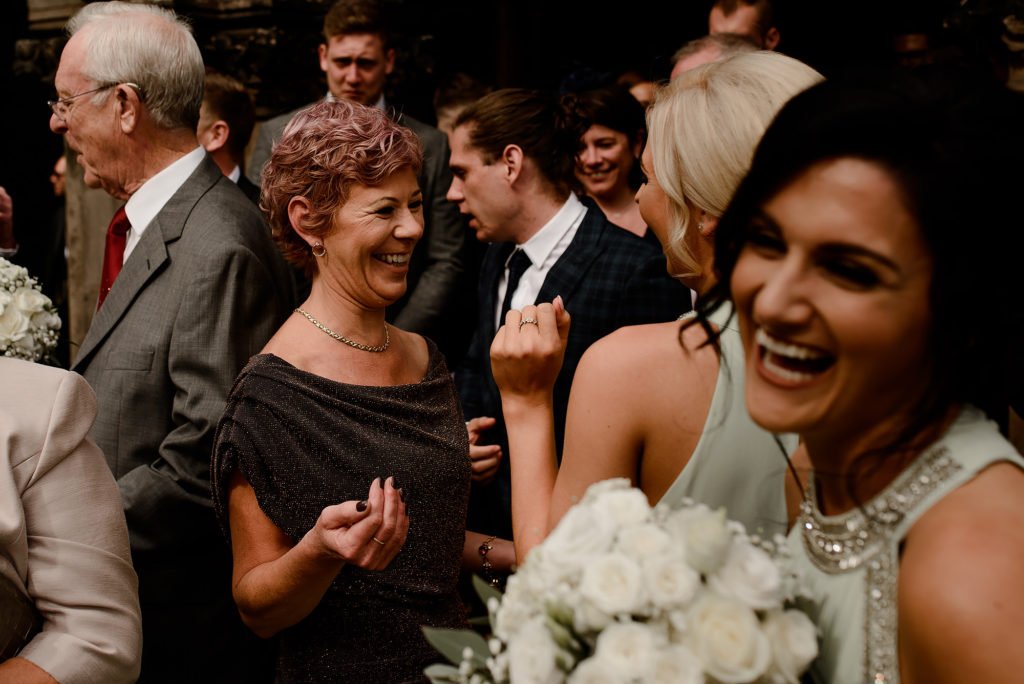 Wedding Guests laughing outside church