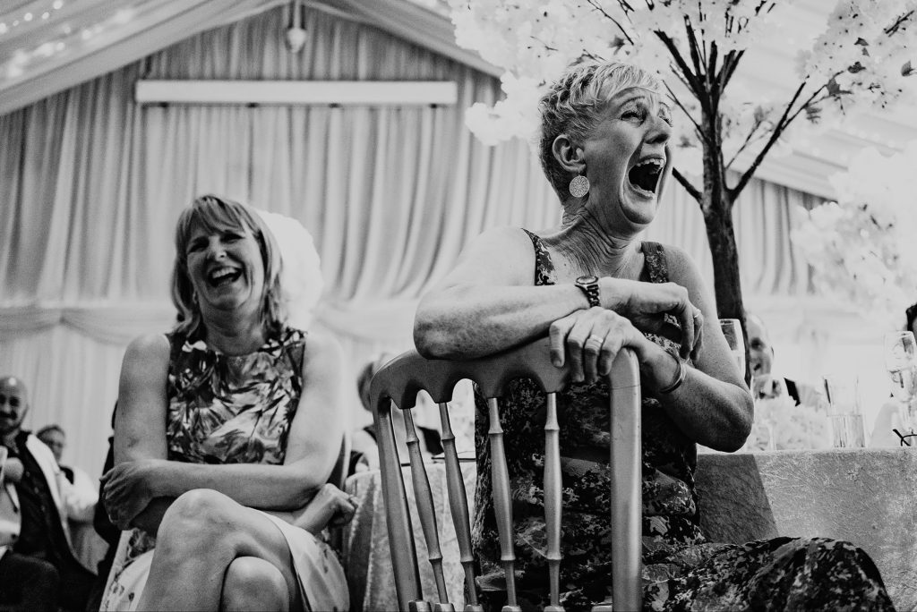 Wedding Guests laughing at the speeches