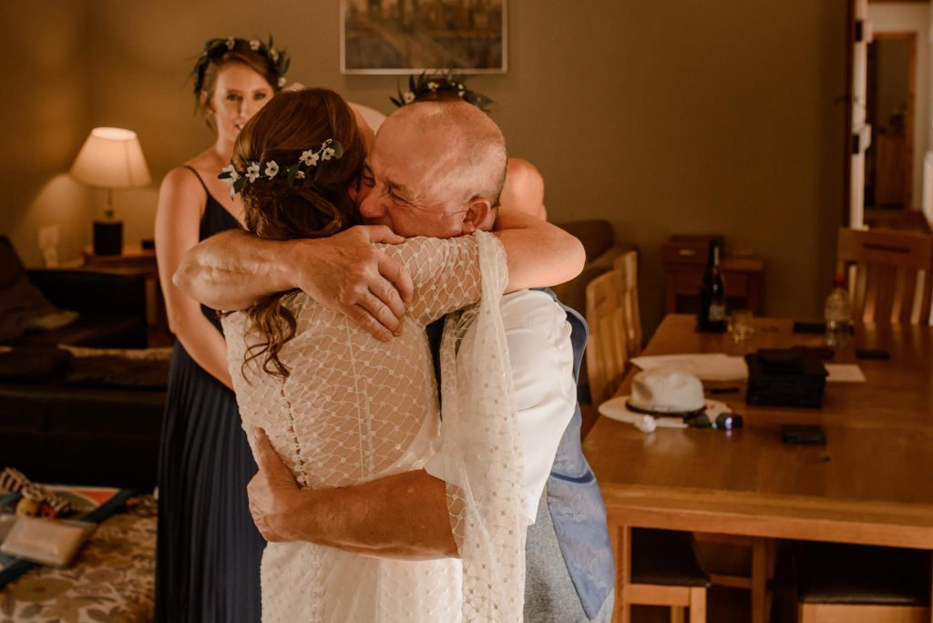 Father of the Bride hugging his daughter and crying
