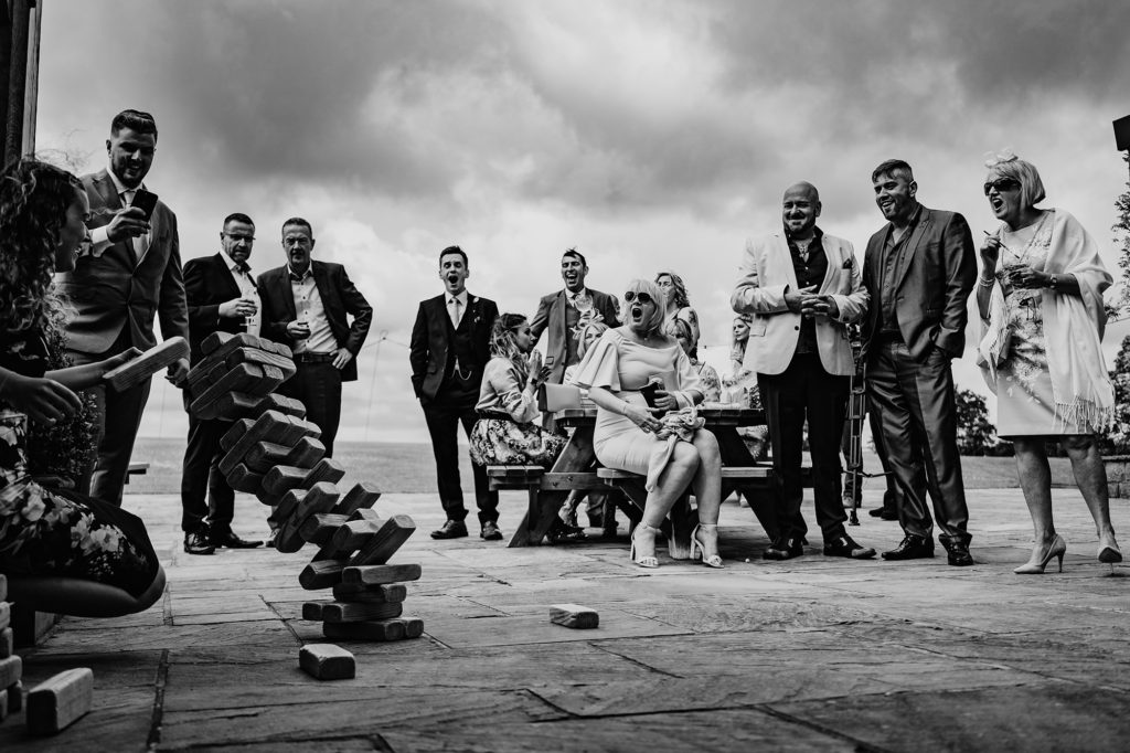 Wedding Guests watching jenga fall over