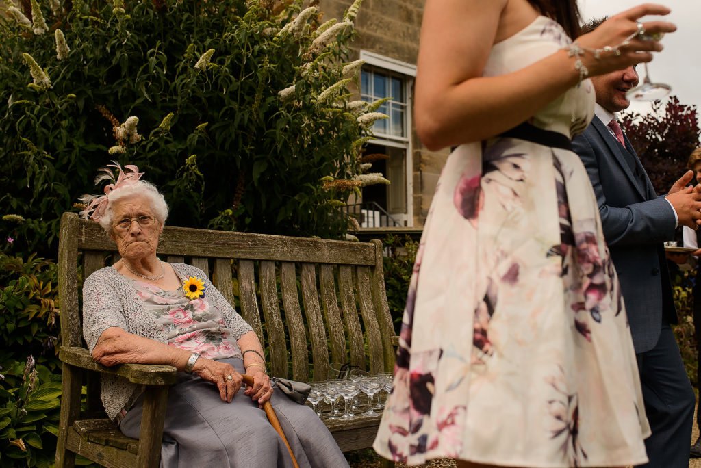 Elderly Wedding Guest sat on a bench