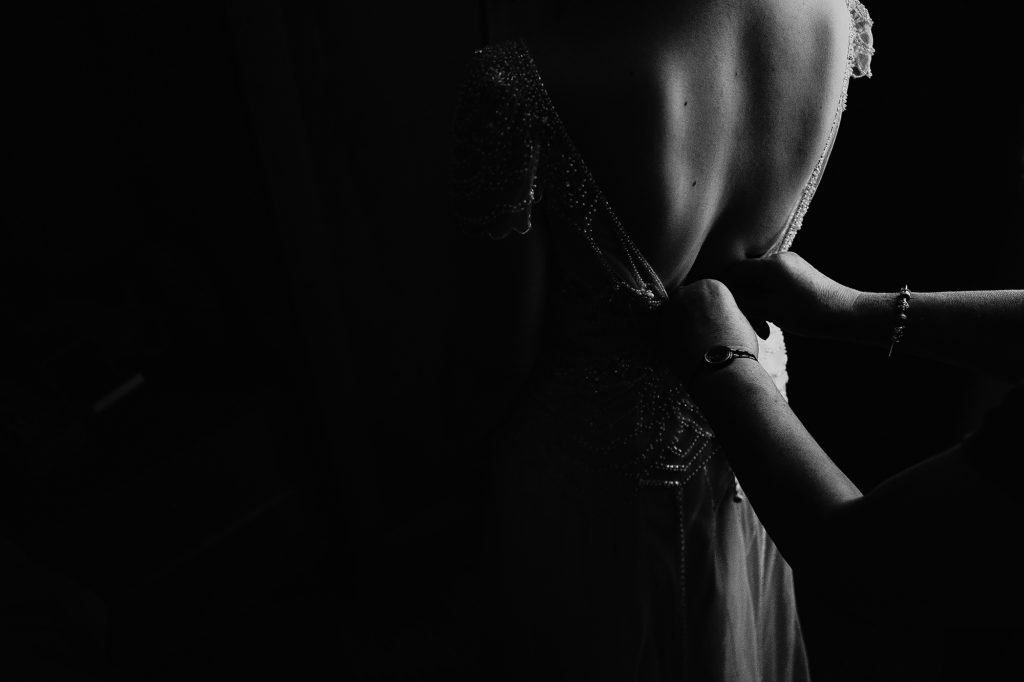 Photograph of the Bride's dress being fastened