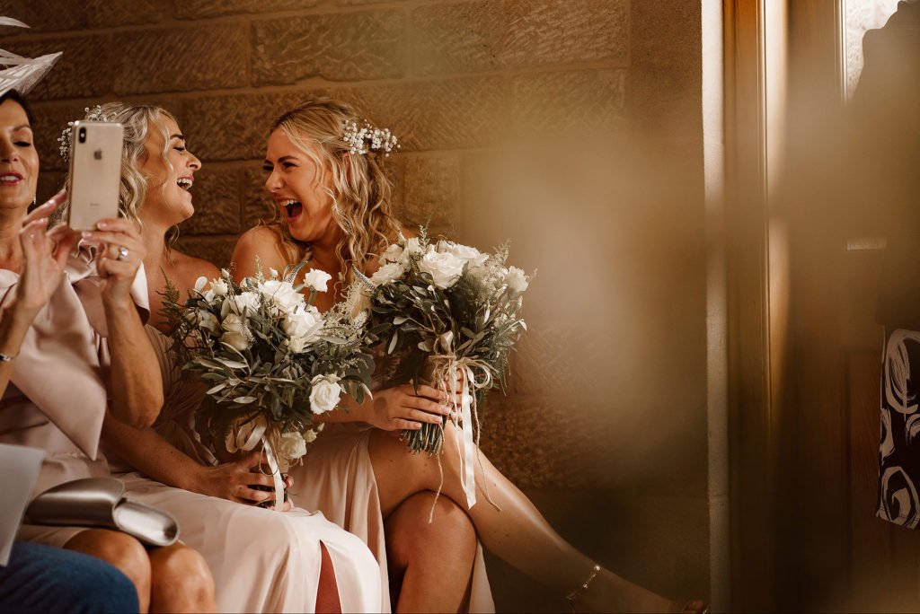 Bridesmaids laughing during the wedding ceremony