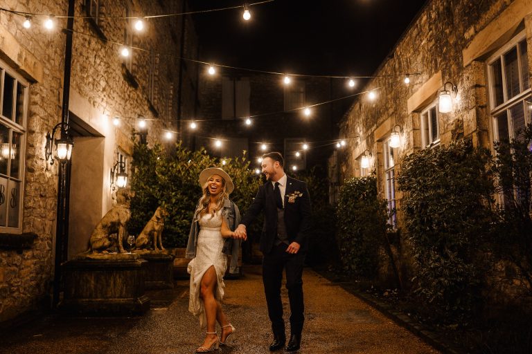 Couple dancing under festoon lighting