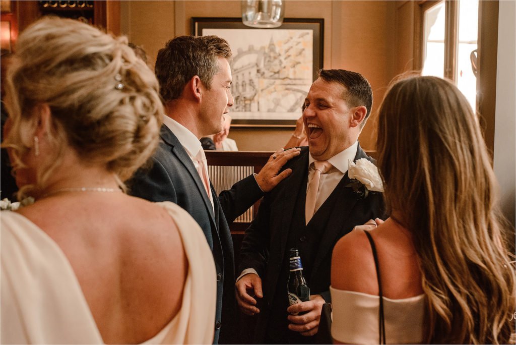 Groom laughing with his Wedding Guests