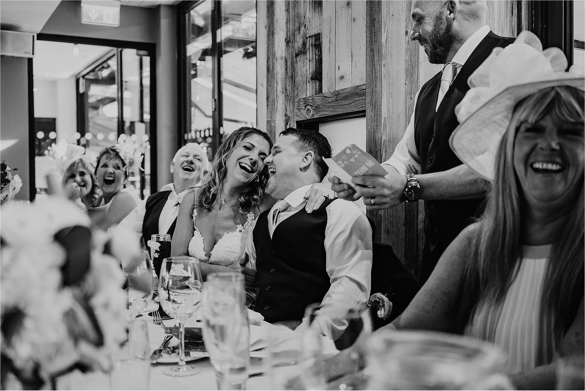 Bride and Groom laughing together at the speeches