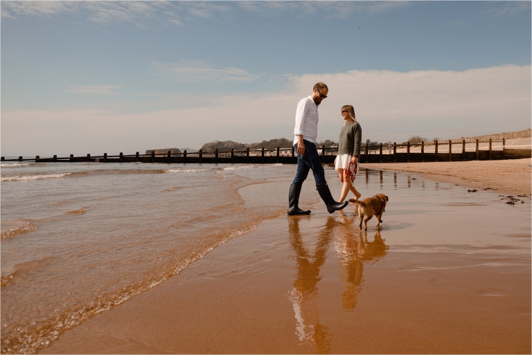 Couple in sea with their dog