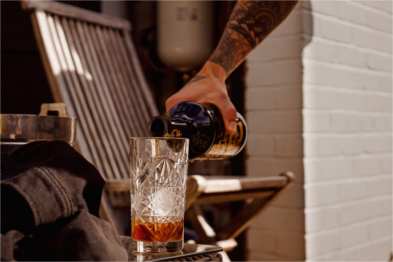 Hand pouring rum into a glass