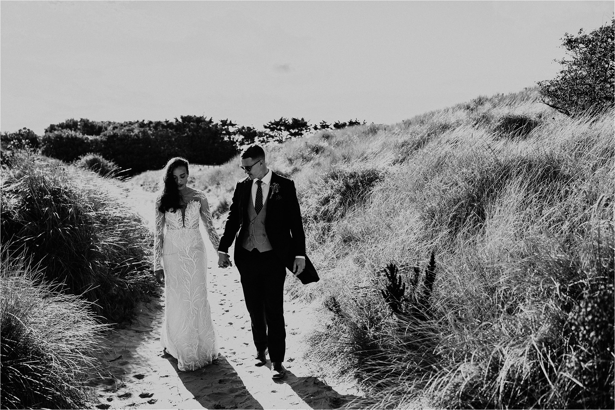 Bride and Groom holding hands and walking