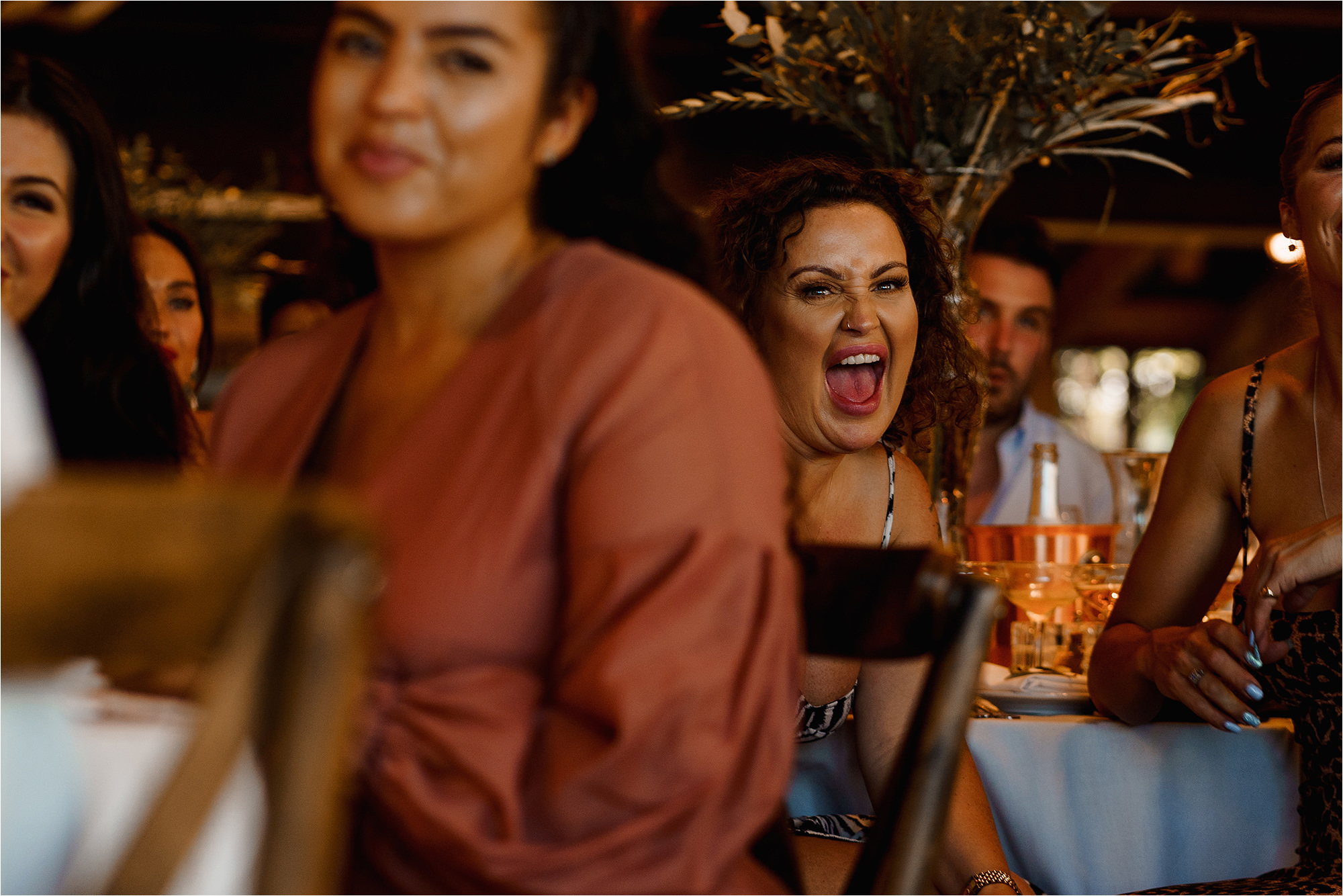 Wedding Guests laughing at the speeches