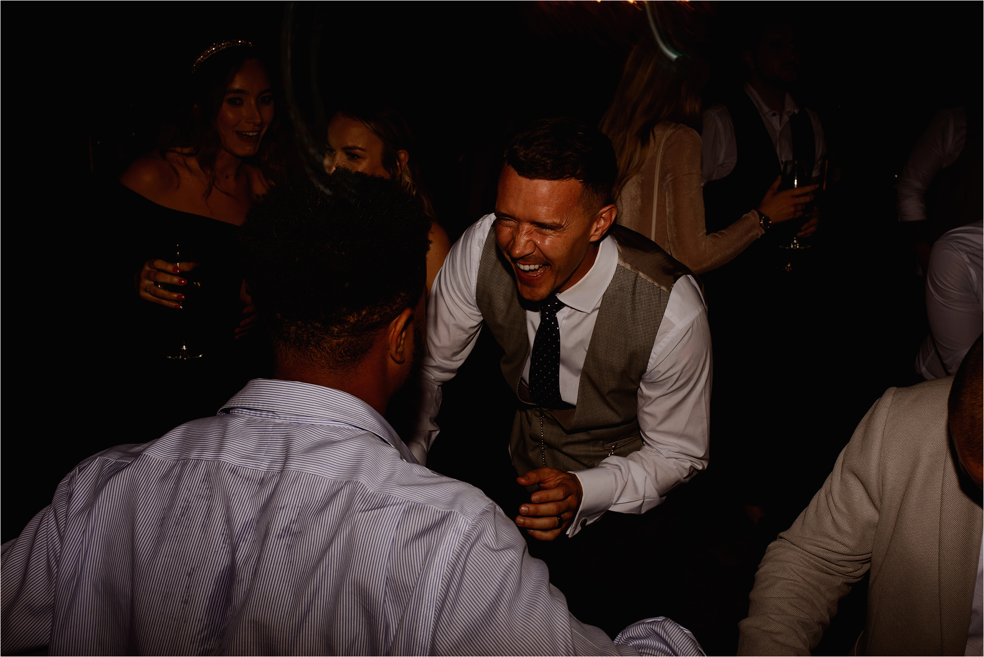 Groom laughing with Wedding Guests