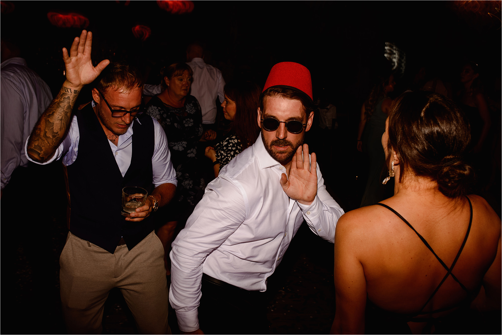 Wedding Guest wearing a fez hat on the dance floor