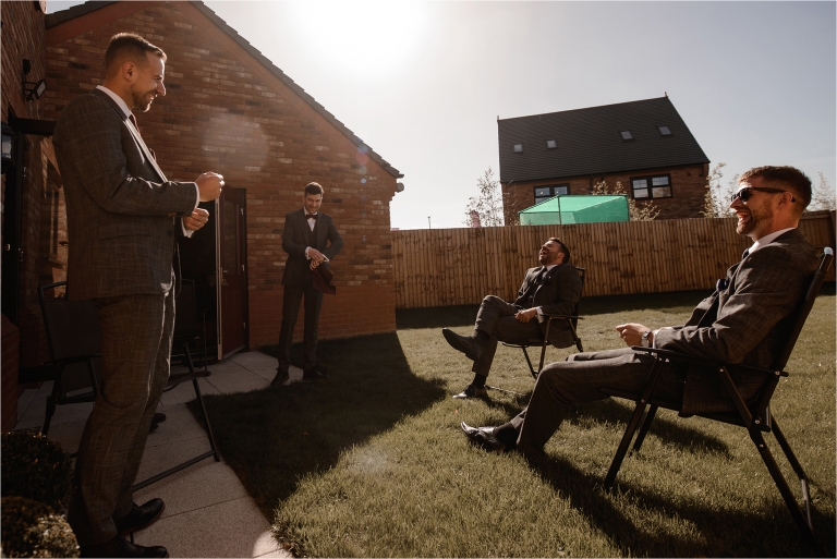 Groom and Groomsmen having a drink in the garden