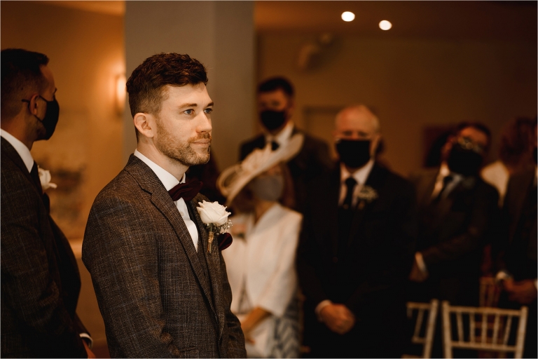 Groom nervously waiting at the top of the aisle