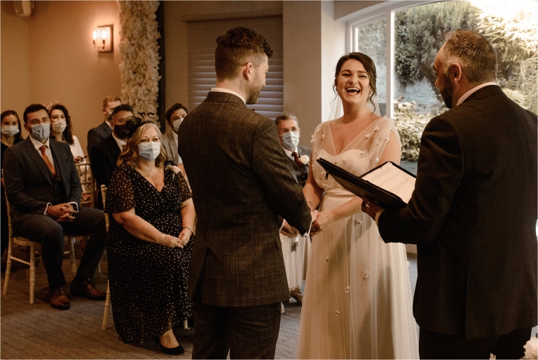 Bride and Groom laughing during their wedding ceremony