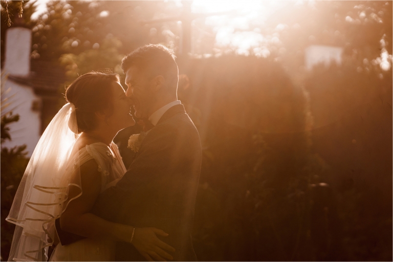 Bride and Groom kissing in golden light