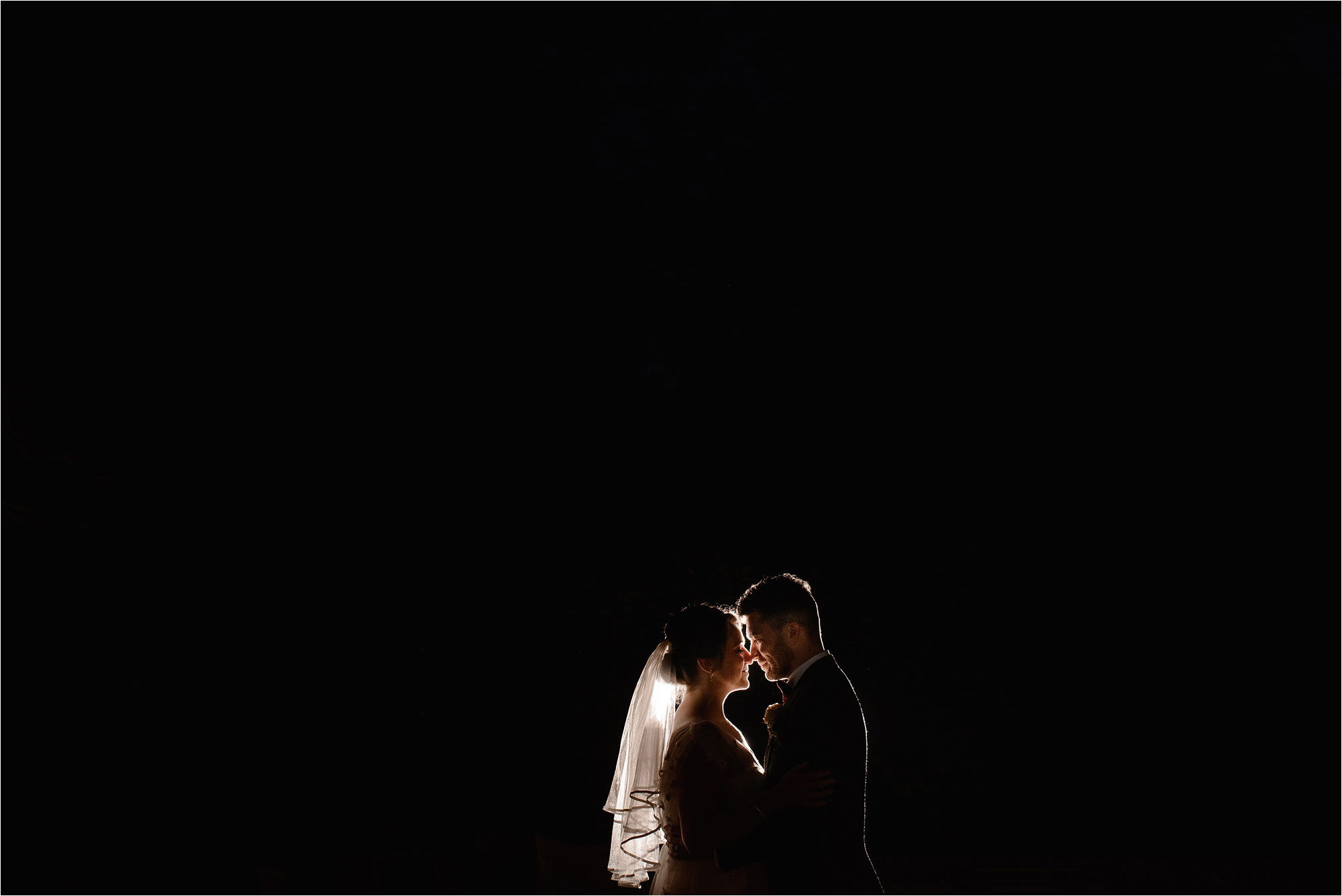 Wide shot of Bride and Groom lit with off camera flash at The Bridge Prestbury
