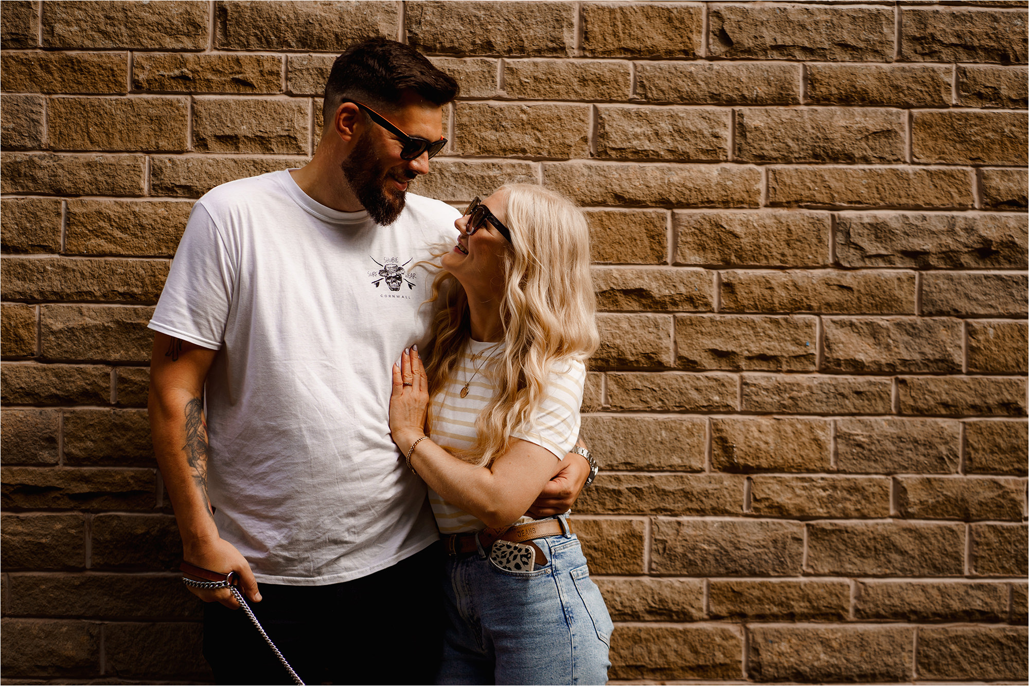 Couple leaning on wall