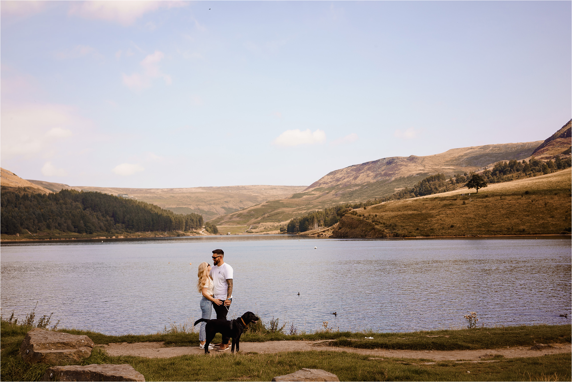 Couple with dog in front of Dovestone Reservoir