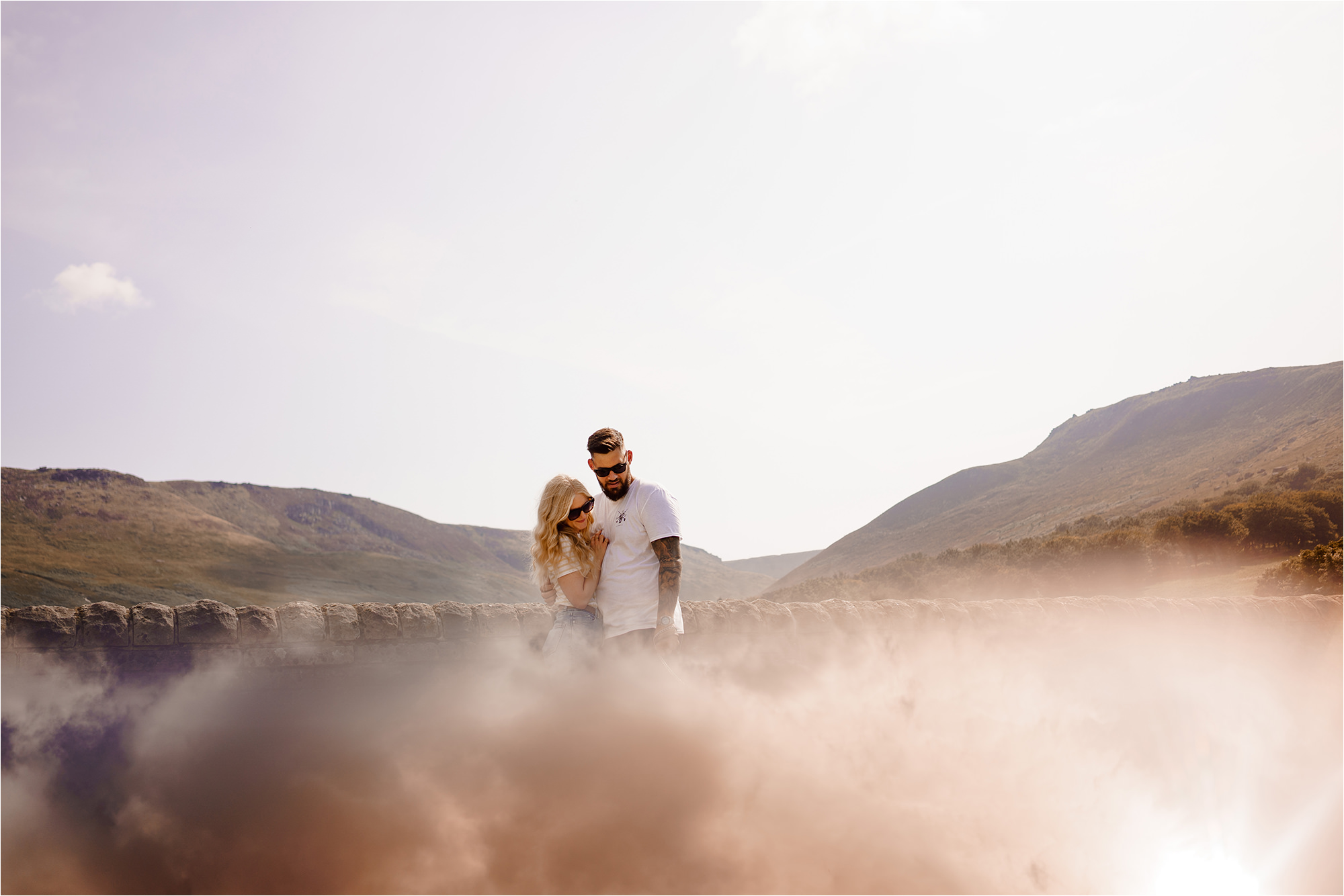 Couple with reflection of clouds at the bottom