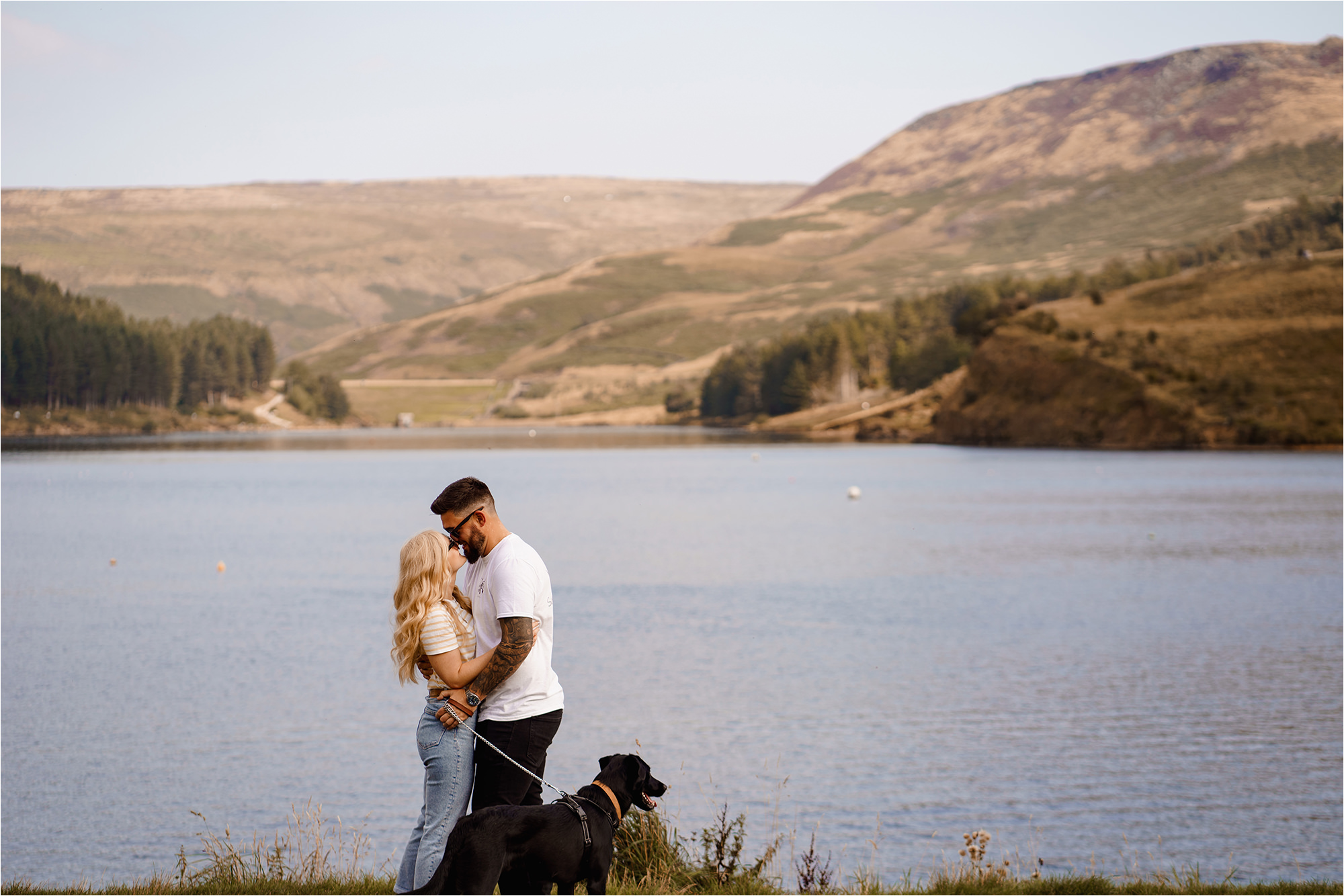 Couple close together in front of reservoir