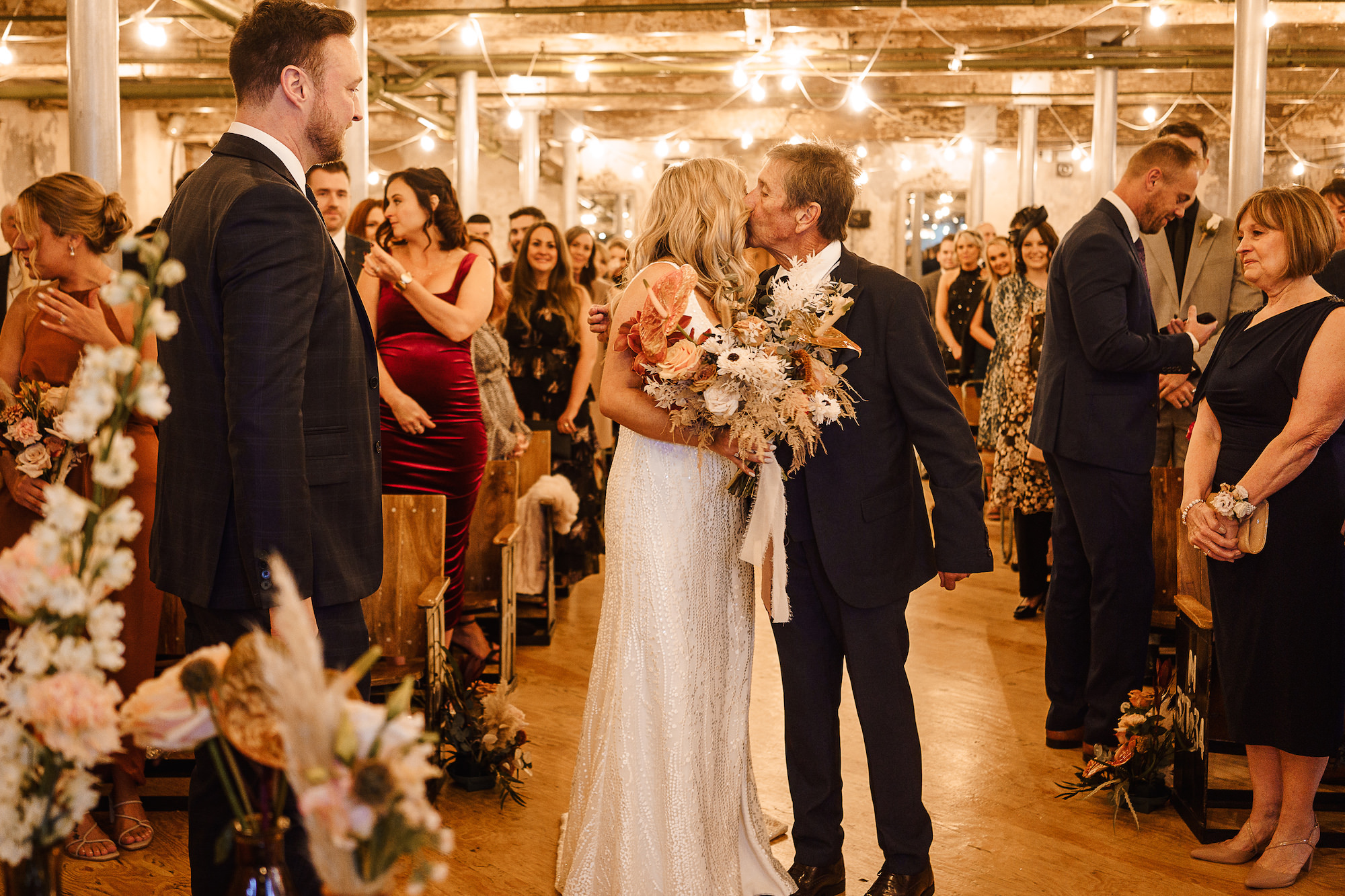 Bride kissing her father as he gives her away