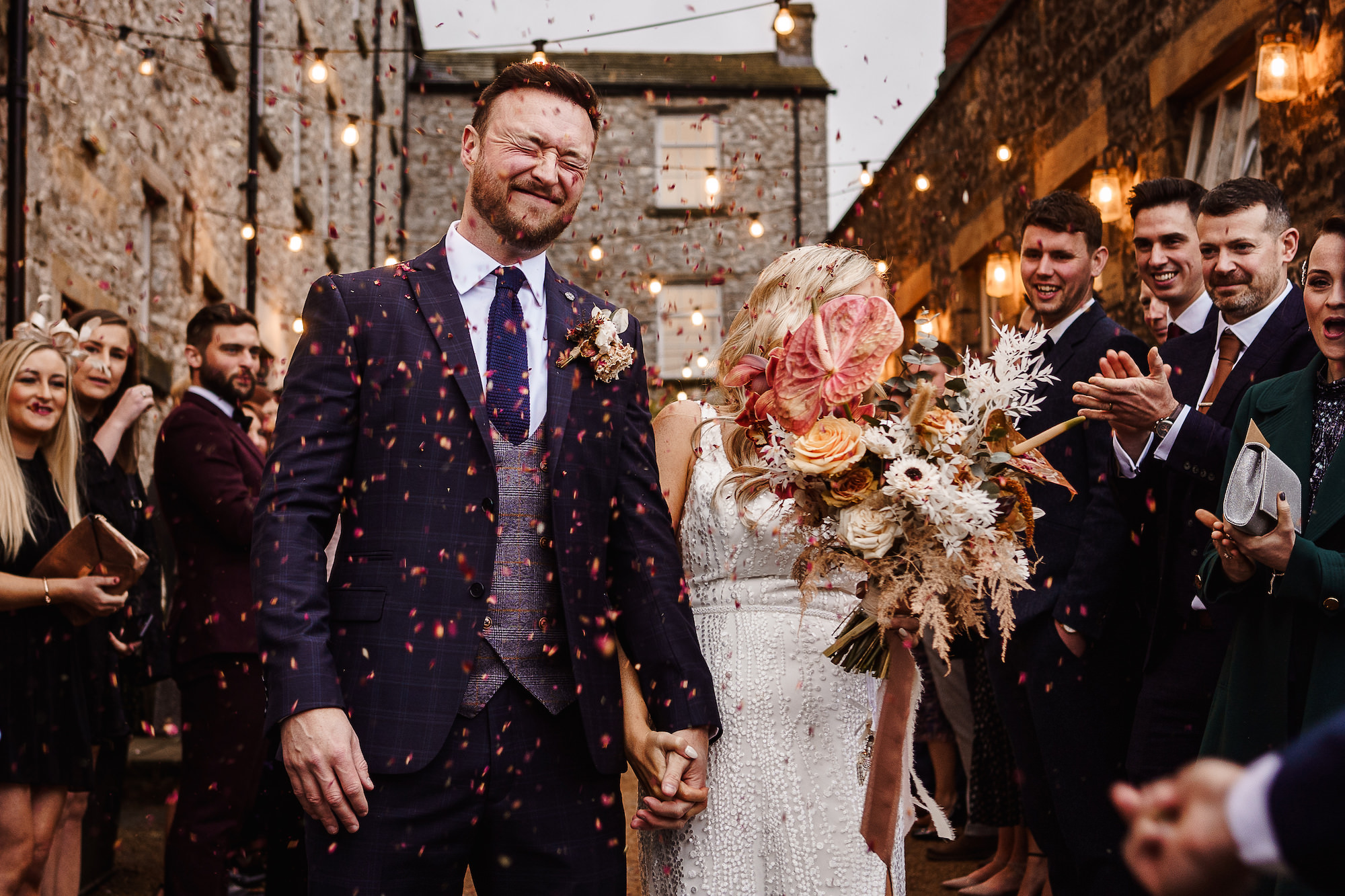 Groom getting confetti thrown in his face