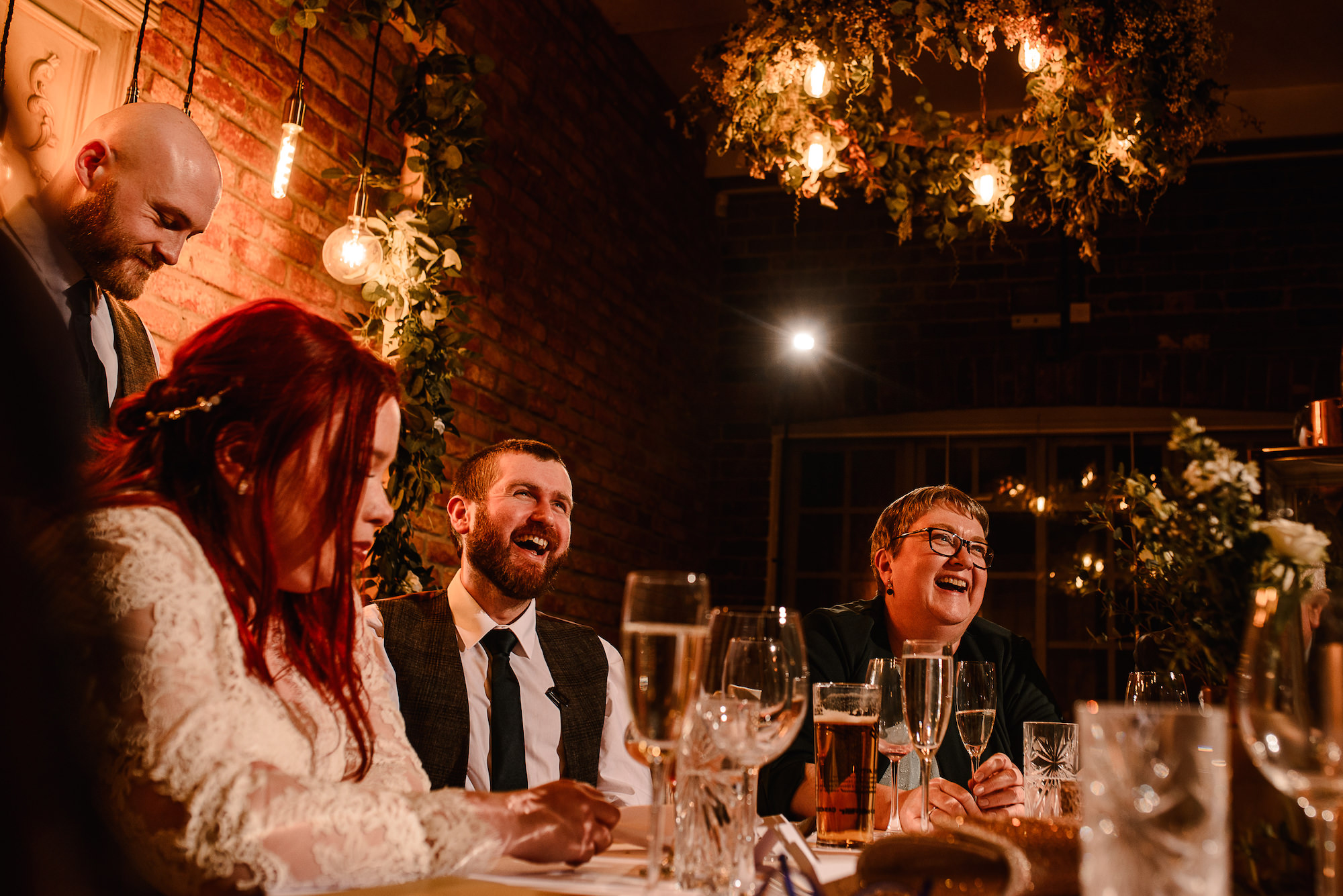 Groom laughing during speeches