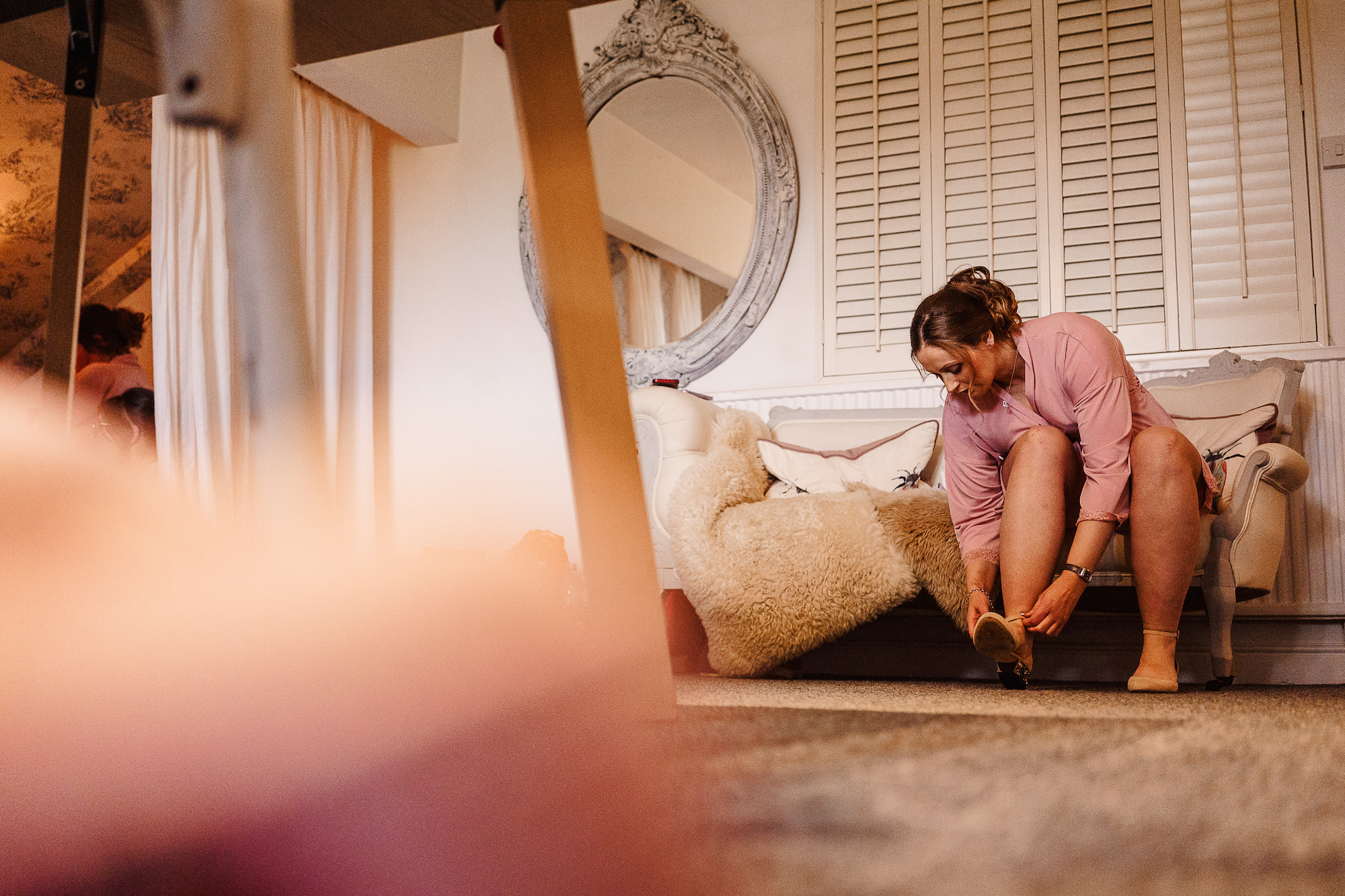 Bridesmaid tying shoe