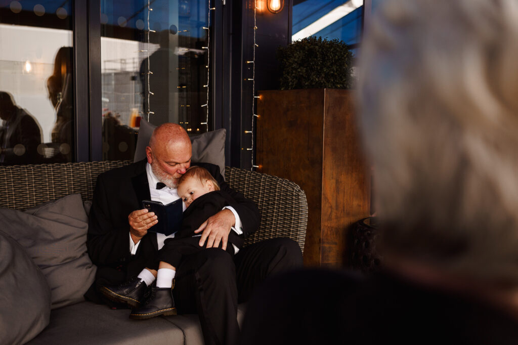 Little boy asleep on man's knee