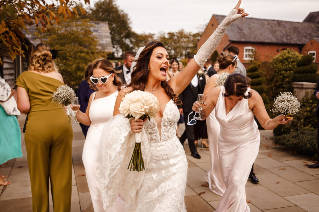 Bride pointing her finger in the air while dancing
